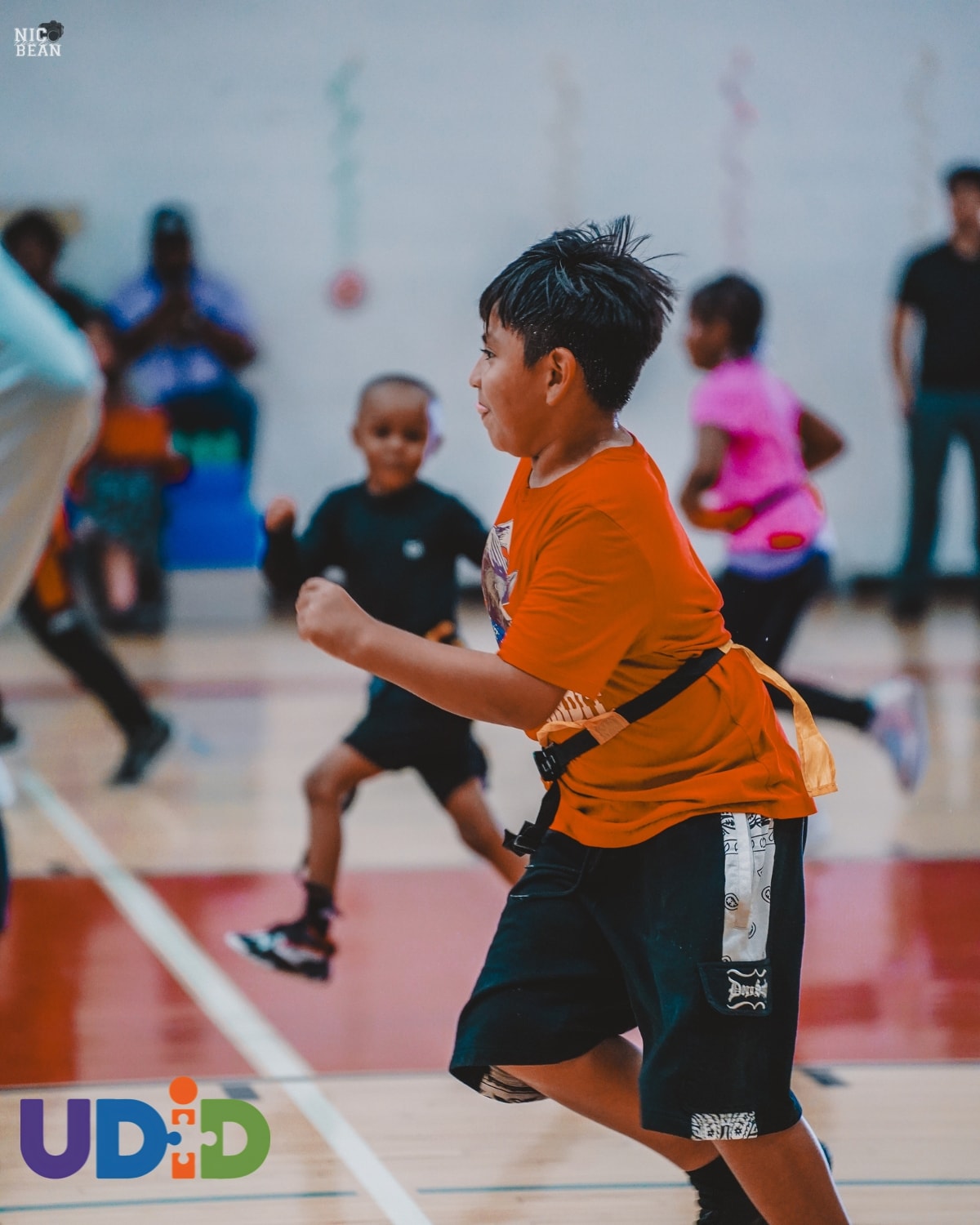 Coach mentoring youth during UDID Academy fitness session